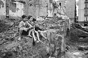01100 Prints: Scenes in Naples, southern Italy showing local children playing on a pile of rubble