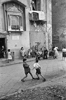 Scenes in Naples, southern Italy showing young boys entertaining themselves