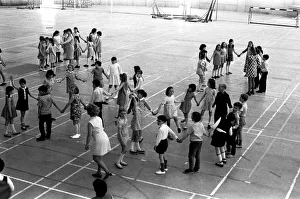 00114 Prints: School children take part in an end of school year dance at the Lightfoot Stadium in