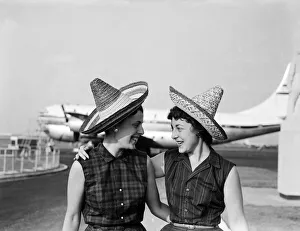 School teacher, 23 year old Phyllis Kaulfman (left), is not short of hats for her flight