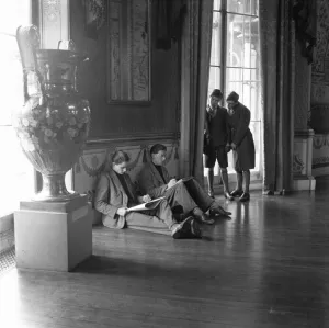 Drawing Prints: Two schoolboys look on as artists sketch in the public library in the Pavilion in