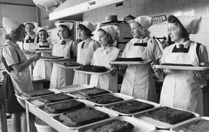 01466 Prints: Schoolgirls serve meals to children during the Second World War. 28th October 1941