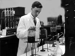 00187 Prints: Science Bunsen Burner August 1926 A chemist testing dyes on woollen material in