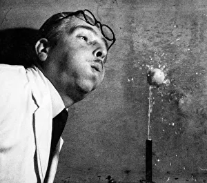 Scientist Prints: A scientist seen here carrying out an expiriment in high speed photography using a small