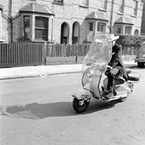 00064 Prints: Scooter: Martin Coleman seen here riding his Lambretta scooter. March 1958 A663