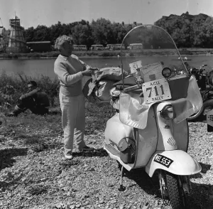 Scooter rally 1958 Woman checks bags Final preparations before