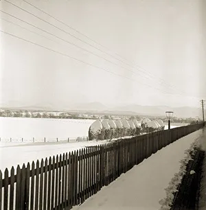 Fence Prints: Scotland covered in snow as a steam traintravels from Perth northwards to the Forres in