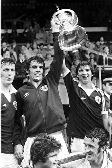00269 Prints: Scotland footballer Joe Jordan holds aloft the British International Football trophy with