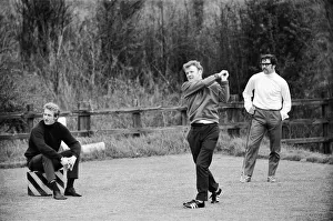 Scotlands Billy Bremner tees off watched by Denis Law during a game of golf