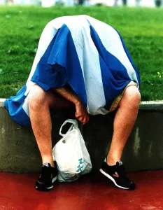 Flags Prints: Scots football fan Italia 1990 World Cup dejected Scotland fan sits on a wall