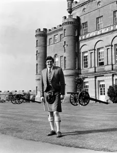 Castle Prints: Scottish comedian Jimmy Logan standing outside Culzean castle wearing traditional