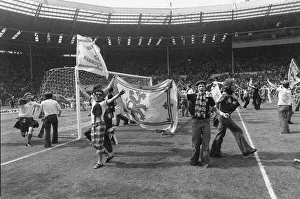 Tartan Prints: Some of the Scottish fans who invade the Wembley pitch following their 2-1 victory
