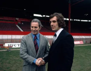 Scottish forward Joe Jordan shakes hands with manager Dave Sexton after signing for new