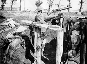 Trenches Prints: Scottish machine gunner keeps watch from a front line trench 1917