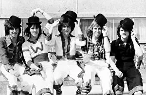 Images Dated 1st April 1975: Scottish pop group The Bay City Rollers, sitting on a bench Wearing bowler hats