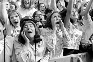 Screaming Beatles fans cheer for their idols on the streets of New York City