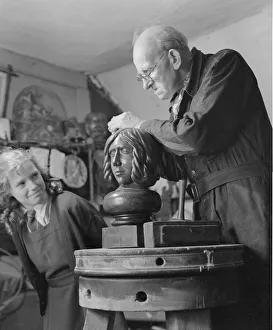 Staring Prints: Sculptor William Snell seen here at work in his studio being watch by his schoolgirl