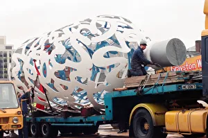 Sculpture Prints: The sculpture Bottle of Notes is lifted off its low loader in the Central
