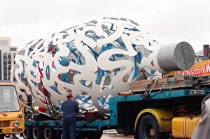 00834 Prints: The sculpture Bottle of Notes is lifted off its low loader in the Central