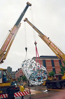 00834 Prints: The sculpture Bottle of Notes is lifted off its low loader in the Central