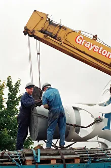 00834 Prints: The sculpture Bottle of Notes is lifted off its low loader in the Central
