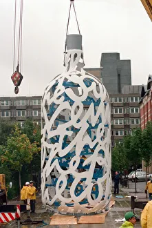00834 Prints: The sculpture Bottle of Notes is lifted off its low loader in the Central