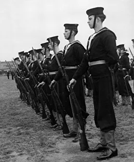 Recruitment Prints: Sea Cadets with bayonets fixed, listening to a memorial service for HMS Jervis Bay