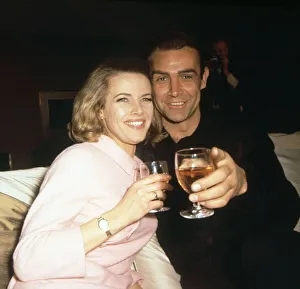 Sean Connery and Honor Blackman enjoy a drink