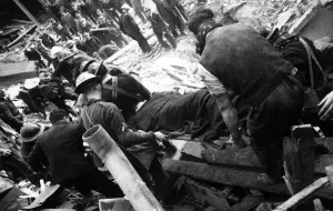 Air Raids Prints: Second Great Fire of London - Stretcher party carry a rescued man over the debris which