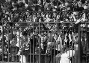 Standing Prints: A section of the caged fans at the Stretford End of Old Trafford watching the match