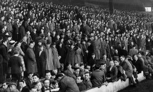 A section of the crowd on the Spion Kop at Anfield waiting for the sale of tickets for