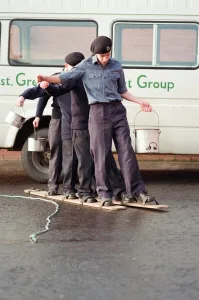 Organisation Prints: Senior officers look on in amusement as Sea Cadets struggle through this