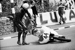 Motorbike Collection: Senior TT race, Isle of Man. Alan Dugdale picks up his bike. 8th June 1964