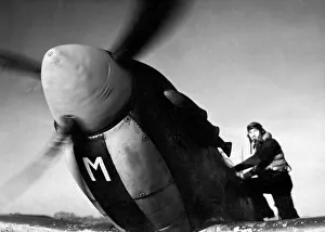 Pilot Prints: Sergeant S. W. Loader of New Barnet climbs into his Spitfire fighter plane to join a