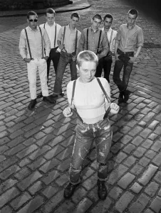Seventeen year old skinhead teenager Janet Askham poses with her friends at her home in
