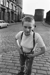 Seventeen year old skinhead teenager Janet Askham poses in the street at her home in