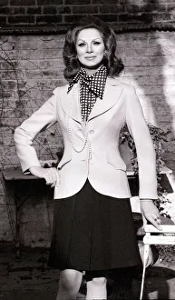 Sex change model April Ashley wearing a white blazer polka dot scarf
