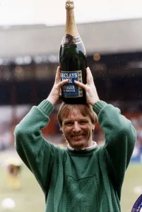 00382 Prints: Sheffield United football manager Dave Bassett holds a bottle of champagne above his head