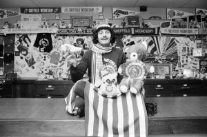 Sheffield Wednesday footballer Terry Curran decked out in the teams rosettes