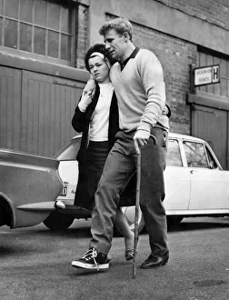 Walking Stick Prints: Sheffield Wednesday Hero, Vic Mobley is helped to his car by his pretty wife Barbara