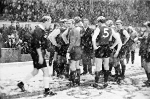 Snowing Prints: Sheffield Wednesday manager Alan Brown surrounded by his players as referee E. T