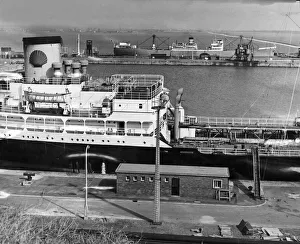 A Shelloil tanker unloading at her berth at the Queen Elizabeth II oil dock at Eastham