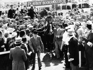 Shergar with jockey Walter Swinburn being led in by the Aga Khan after winning the Derby