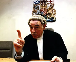 Judge Prints: Sheriff J. Irvine Smith, poses pointing his finger wearing wig and gown