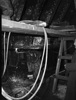 Shipbuilders at the King George V dry dock in Southampton replace damaged hull plates of