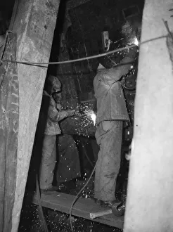 Shipbuilders at the King George V dry dock in Southampton replace damaged hull plates of