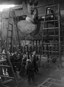 Shipbuilders at the King George V dry dock in Southampton replace one of the mighty