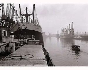 Ships unloading in the docks at Manchester seen through the mist May 1967
