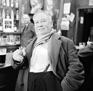 A shipyard worker seen here enjoying a whisky chaser and a pint after knocking off work
