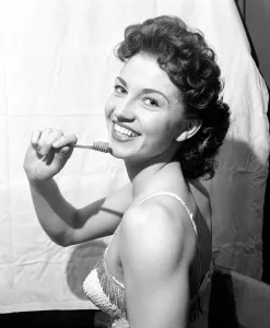 Toothbrush Prints: Shirley Dennis who hangs by her teeth twice nightly October 1957